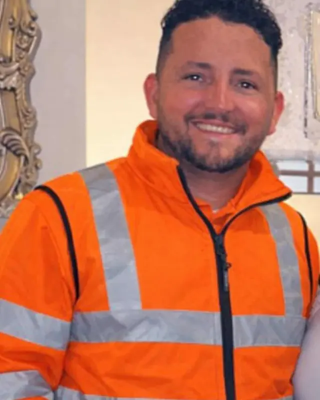 Michael of Edinburgh Paving & Landscaping wearing an orange high-visibility jacket